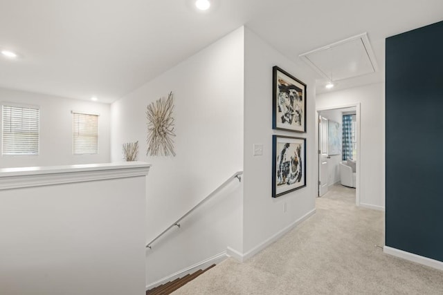 corridor featuring light colored carpet