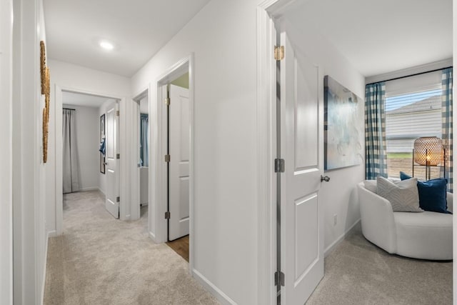 hallway featuring light carpet