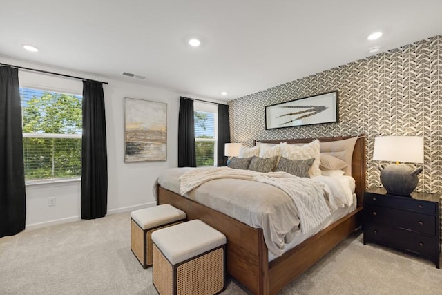 carpeted bedroom featuring multiple windows