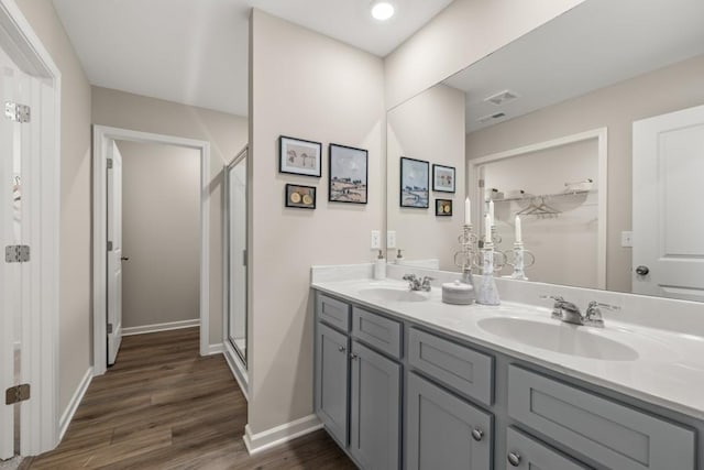 bathroom with vanity, wood-type flooring, and walk in shower