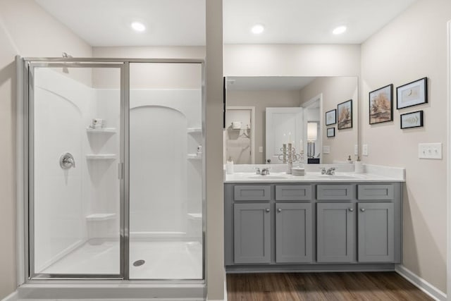 bathroom featuring a shower with door, vanity, and hardwood / wood-style flooring