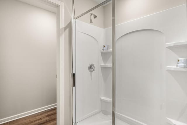 bathroom with wood-type flooring and walk in shower