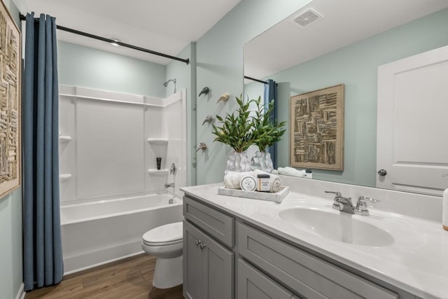 full bathroom with toilet, vanity, shower / bathtub combination, and hardwood / wood-style flooring