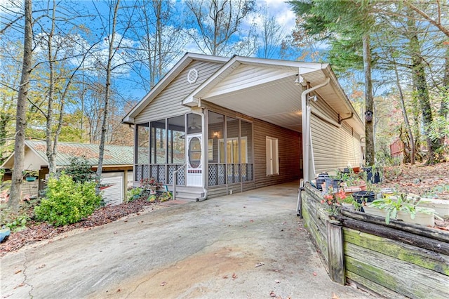 view of front of house with a carport and a sunroom