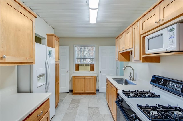 kitchen with light brown cabinetry, white appliances, cooling unit, and sink