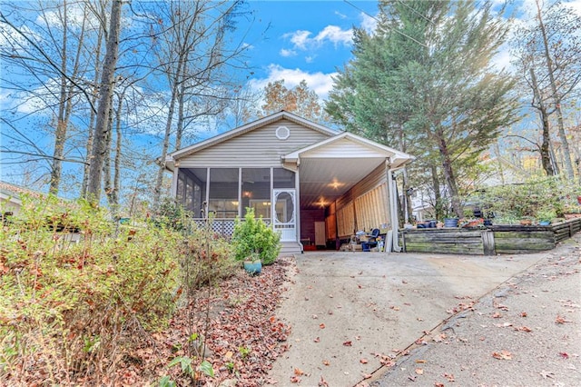 view of front facade featuring a sunroom and a carport