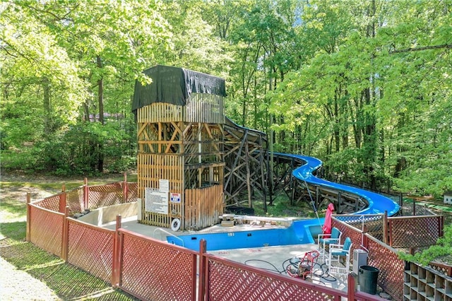 view of jungle gym featuring a swimming pool