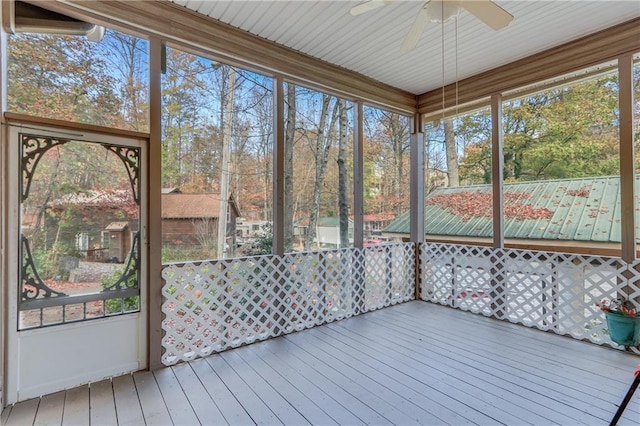 unfurnished sunroom with ceiling fan and plenty of natural light