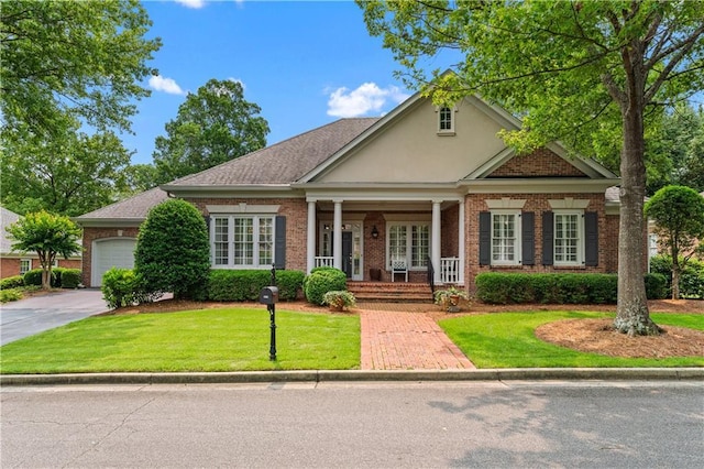 2117 Stephens Walk, Dunwoody, GA 30338 - view of front of property featuring a porch, brick siding, concrete driveway, and a front lawn