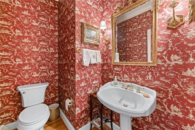 2117 Stephens Walk, Dunwoody, GA 30338 - half bathroom with wood finished floors, baseboards, toilet, and a sink