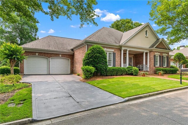 2117 Stephens Walk, Dunwoody, GA 30338 - view of front of house featuring brick siding, a garage, a front lawn, concrete driveway, and a shingled roof
