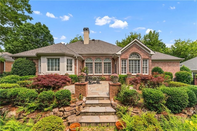 2117 Stephens Walk, Dunwoody, GA 30338 - back of property featuring brick siding, a chimney, and a patio area