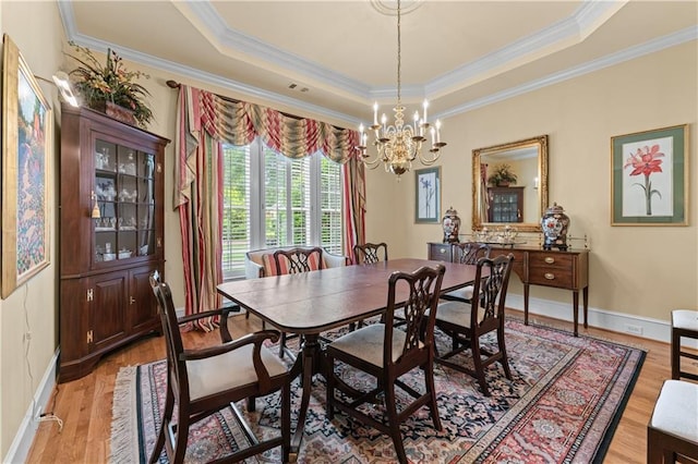 2117 Stephens Walk, Dunwoody, GA 30338 - dining room with light wood-type flooring, a tray ceiling, a chandelier, ornamental molding, and baseboards