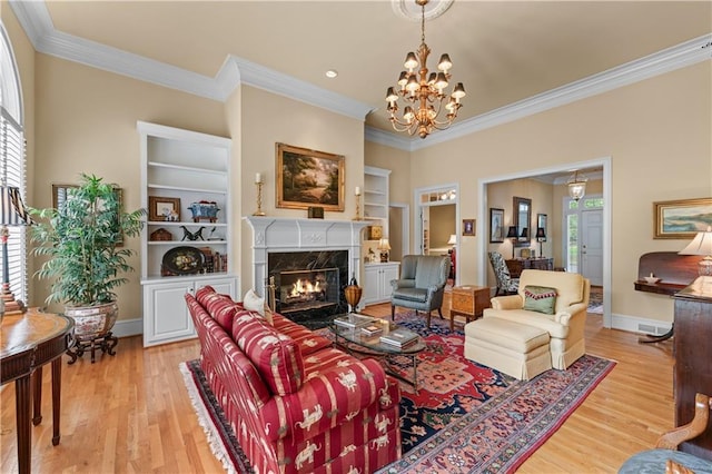 2117 Stephens Walk, Dunwoody, GA 30338 - living room with built in features, crown molding, plenty of natural light, a fireplace, and light wood-type flooring