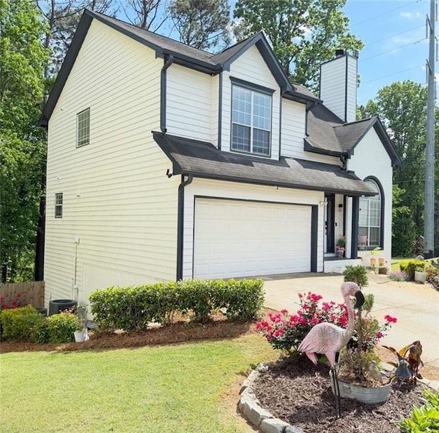 view of side of home featuring a garage, a chimney, a lawn, and driveway