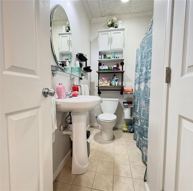 bathroom with tile patterned floors, toilet, and curtained shower