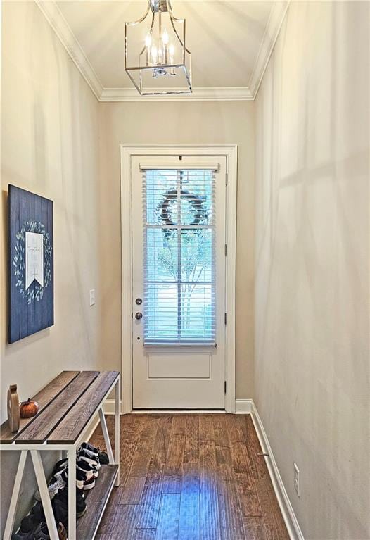 doorway featuring ornamental molding, dark hardwood / wood-style flooring, and a notable chandelier