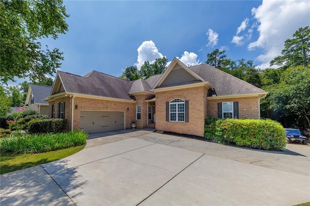 view of front facade featuring a shingled roof, brick siding, driveway, and an attached garage