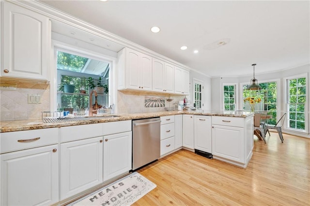 kitchen with dishwasher, healthy amount of natural light, light wood finished floors, ornamental molding, and white cabinetry
