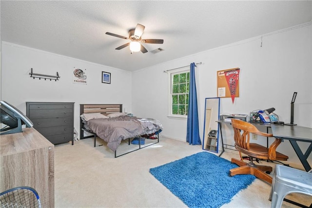 bedroom featuring carpet floors, ceiling fan, a textured ceiling, and a desk