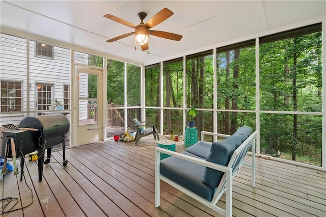 sunroom / solarium featuring ceiling fan