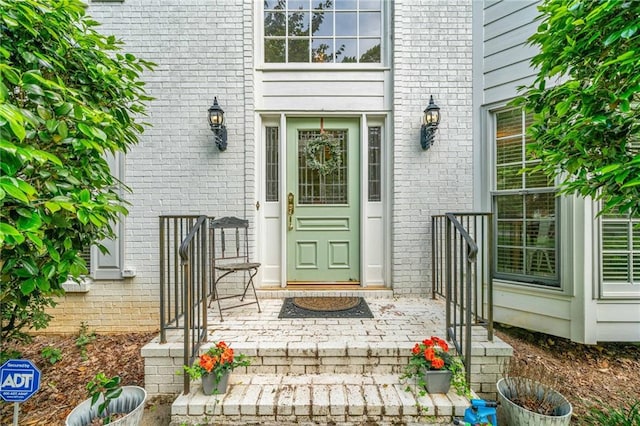 property entrance with brick siding