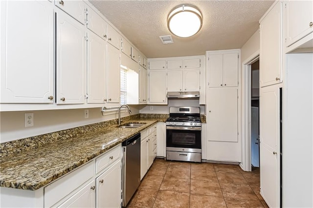 kitchen with white cabinetry, sink, dark stone countertops, a textured ceiling, and appliances with stainless steel finishes