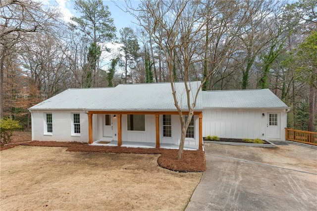 ranch-style house with a porch and brick siding