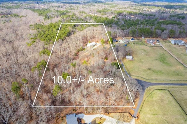 birds eye view of property featuring a rural view