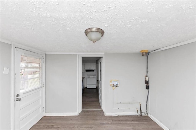 interior space featuring wood finished floors, baseboards, and a textured ceiling