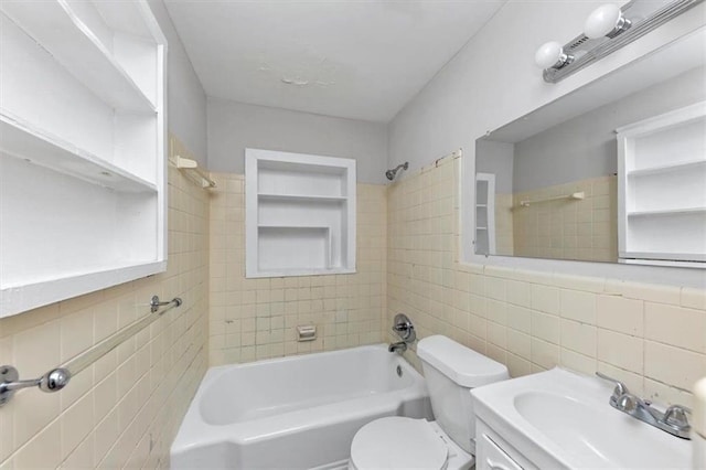 full bath featuring tile walls, toilet, shower / bathtub combination, and a sink