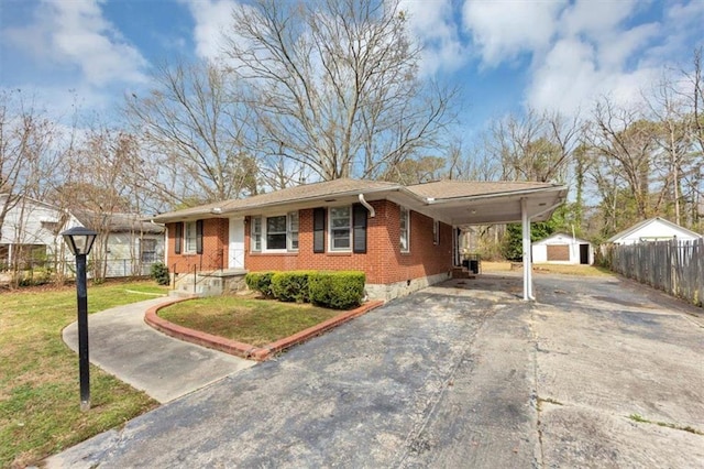 ranch-style house featuring aphalt driveway, fence, crawl space, an attached carport, and brick siding