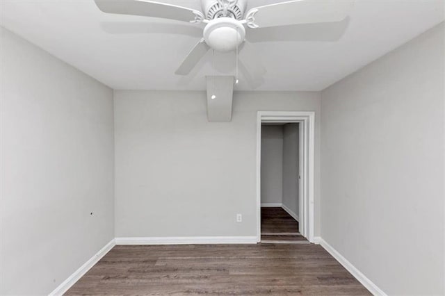 spare room with wood finished floors, baseboards, and ceiling fan