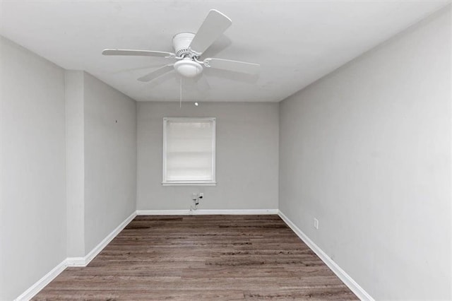 empty room with a ceiling fan, baseboards, and wood finished floors