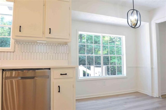 5974 SW Four Winds Dr SW, Lilburn, GA 30047 - kitchen featuring stainless steel dishwasher, decorative backsplash, light countertops, and plenty of natural light