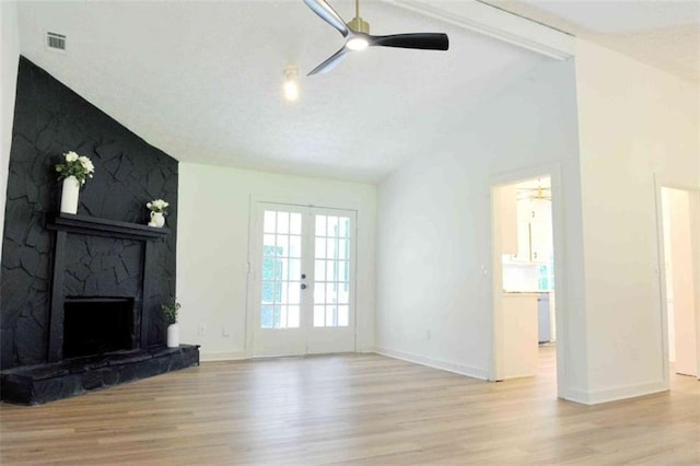 5974 SW Four Winds Dr SW, Lilburn, GA 30047 - unfurnished living room featuring wood finished floors, lofted ceiling, ceiling fan, and a stone fireplace