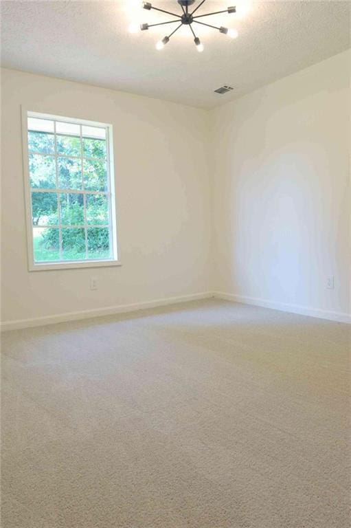 5974 SW Four Winds Dr SW, Lilburn, GA 30047 - unfurnished room with a chandelier, a textured ceiling, and light carpet