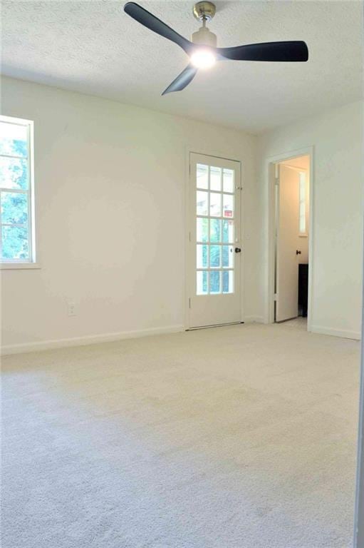5974 SW Four Winds Dr SW, Lilburn, GA 30047 - spare room featuring ceiling fan, plenty of natural light, light carpet, and a textured ceiling