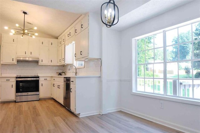5974 SW Four Winds Dr SW, Lilburn, GA 30047 - kitchen featuring a chandelier, appliances with stainless steel finishes, light wood finished floors, and vaulted ceiling