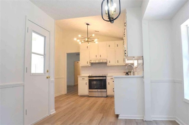 5974 SW Four Winds Dr SW, Lilburn, GA 30047 - kitchen featuring a chandelier, electric range, under cabinet range hood, light countertops, and lofted ceiling