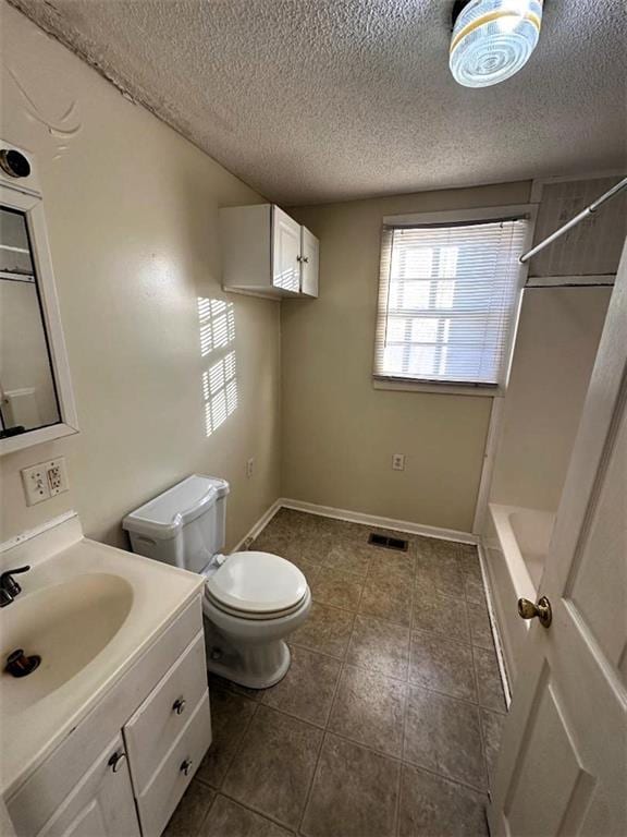 full bathroom featuring vanity, a textured ceiling, toilet, and a wealth of natural light