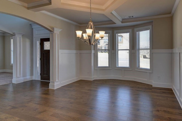 unfurnished dining area featuring coffered ceiling, dark hardwood / wood-style flooring, a notable chandelier, decorative columns, and ornamental molding