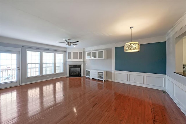 kitchen featuring white cabinets, a kitchen island, appliances with stainless steel finishes, a breakfast bar, and light hardwood / wood-style flooring