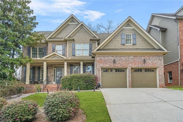 craftsman house featuring brick siding and driveway