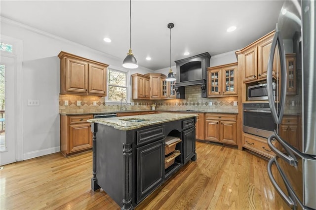 kitchen featuring light wood-style floors, appliances with stainless steel finishes, brown cabinetry, and crown molding