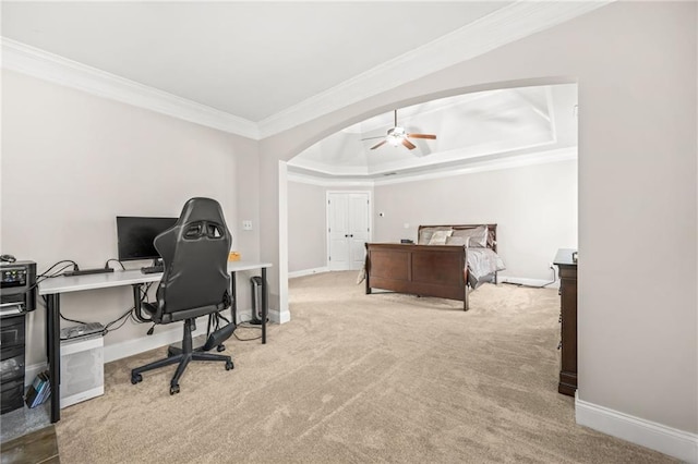 carpeted home office with arched walkways, baseboards, a ceiling fan, and ornamental molding