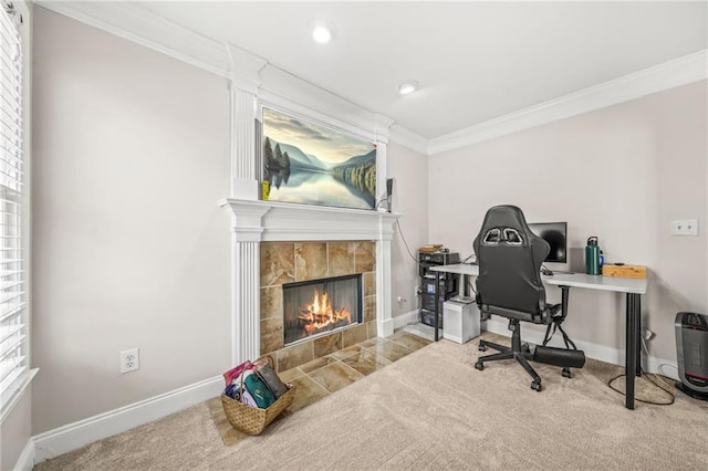 office featuring carpet flooring, baseboards, crown molding, and a tile fireplace