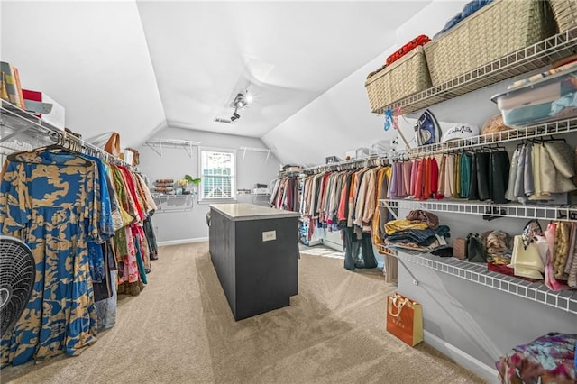 spacious closet with carpet and vaulted ceiling