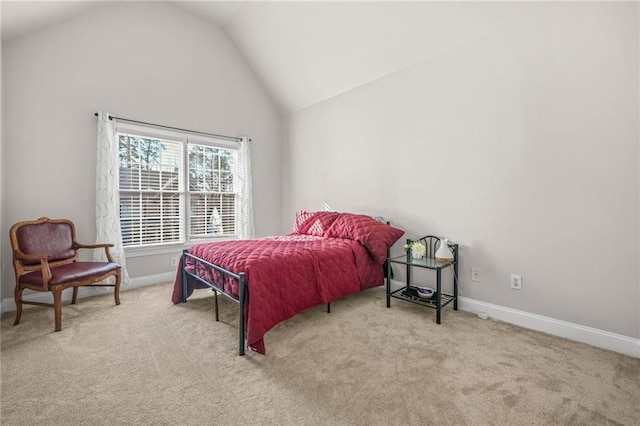 carpeted bedroom featuring baseboards and high vaulted ceiling