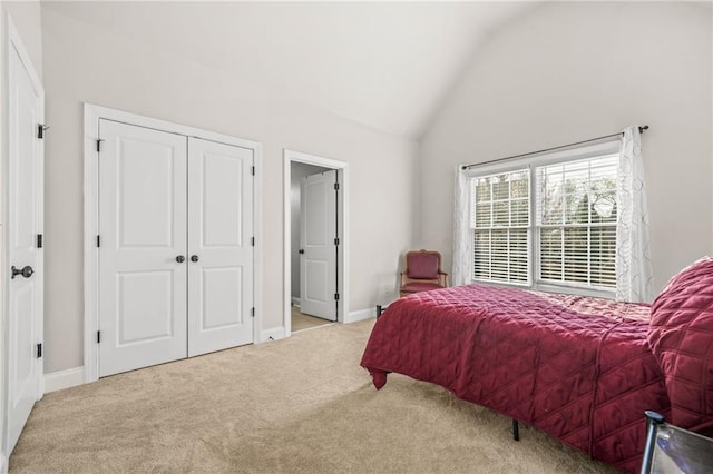 bedroom with baseboards, lofted ceiling, and carpet